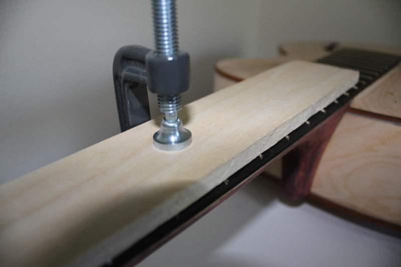 Glueing the new fingerboard to the neck.